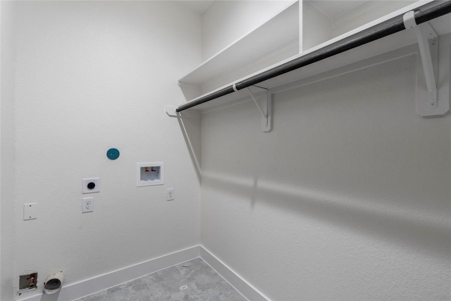 Dedicated laundry room with utility connections and overhead storage. Dedicated laundry room with utility connections and overhead storage.