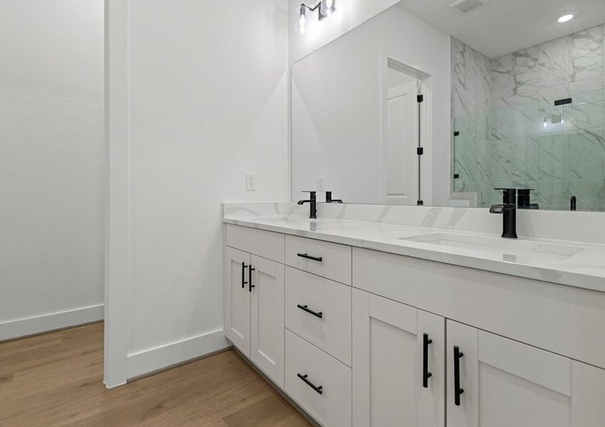 The primary bath is home to ample storage.