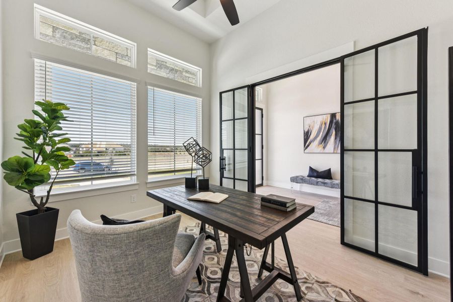 Home office featuring light wood-type flooring and ceiling fan