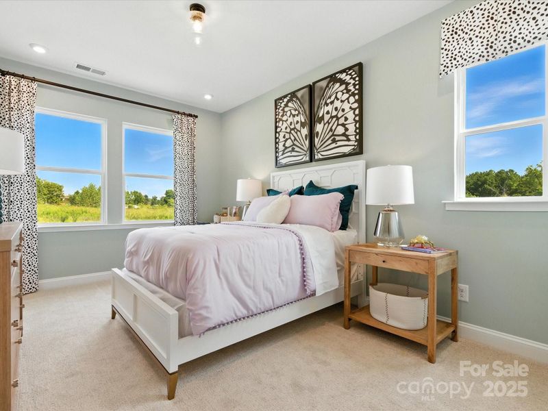 Secondary bedroom with large windows and unobstructed views. *Model Photos | Orientation and structural selections may vary. Secondary bedroom with large windows and unobstructed views. *Model Photos | Orientation and structural selections may vary.