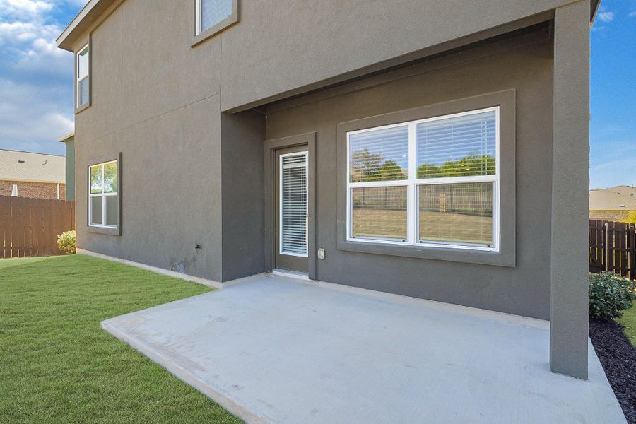 Rear view of property featuring stucco siding and a patio area