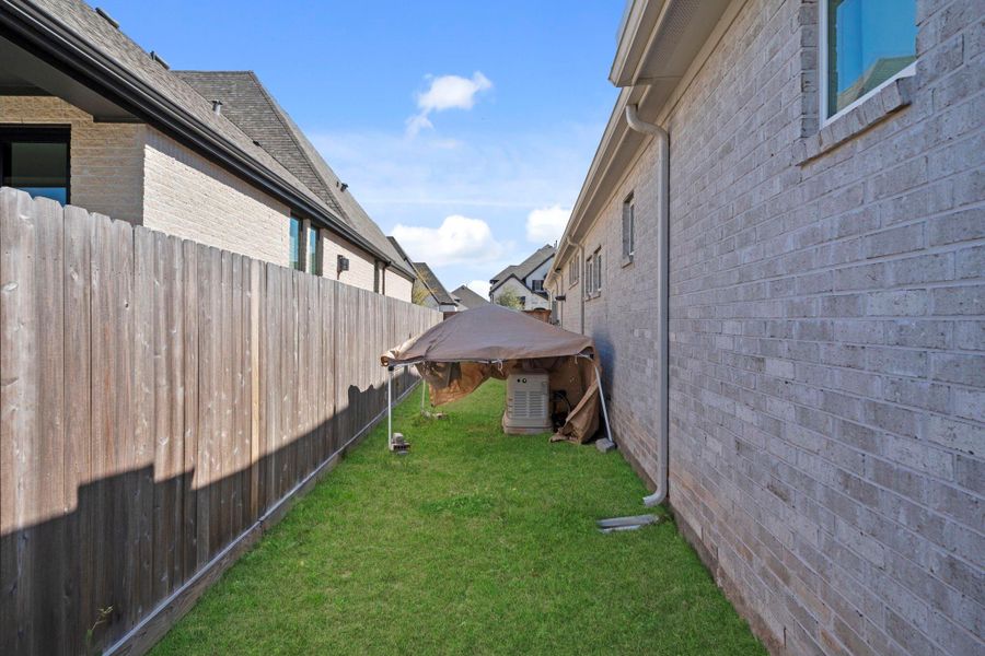 Additional side yard space offering flexibility for storage, pets, or garden potential.