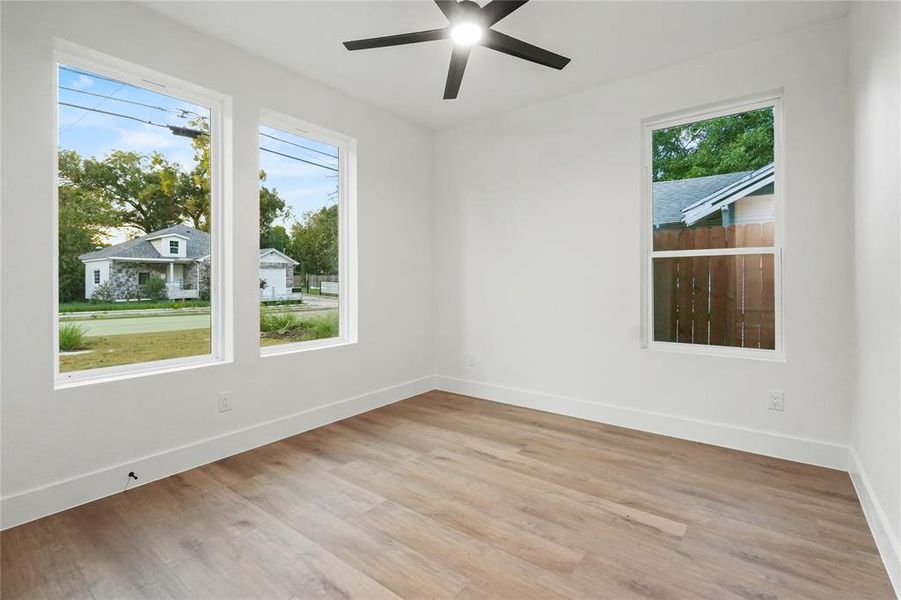 Unfurnished room with light wood-style floors and ceiling fan Unfurnished room with light wood-style floors and ceiling fan