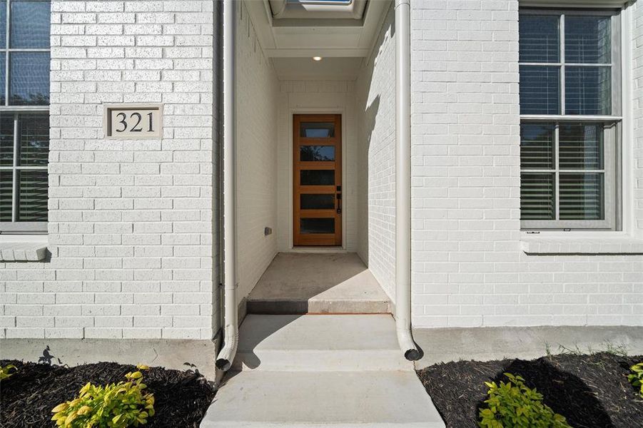 Doorway to property featuring brick siding
