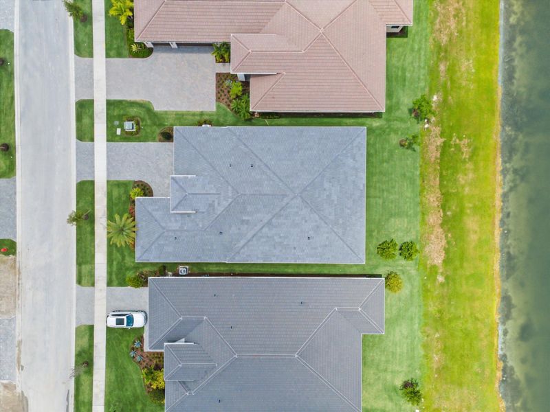 Front exterior of a new home in Cresswind Palm Beach at Westlake, Westlake, FL, highlighting curb appeal (Image 31). Front exterior of a new home in Cresswind Palm Beach at Westlake, Westlake, FL, highlighting curb appeal (Image 31).