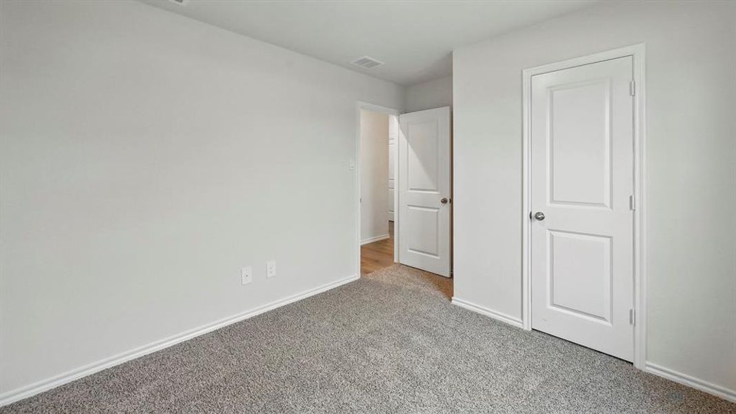 Unfurnished bedroom featuring carpet floors and baseboards