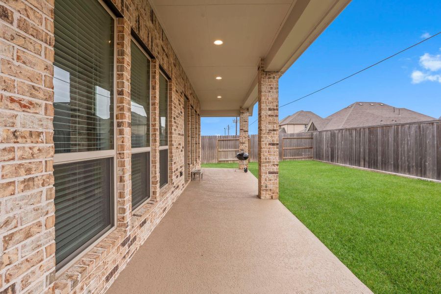 This space is perfect for lounging and enjoying the sights and sounds of nature while waiting for the grill to heat up or relaxing with a cold drink in hand. As the sun sets, you can take in the breathtaking views, making this outdoor area the ideal spot for unforgettable evenings with family and friends.