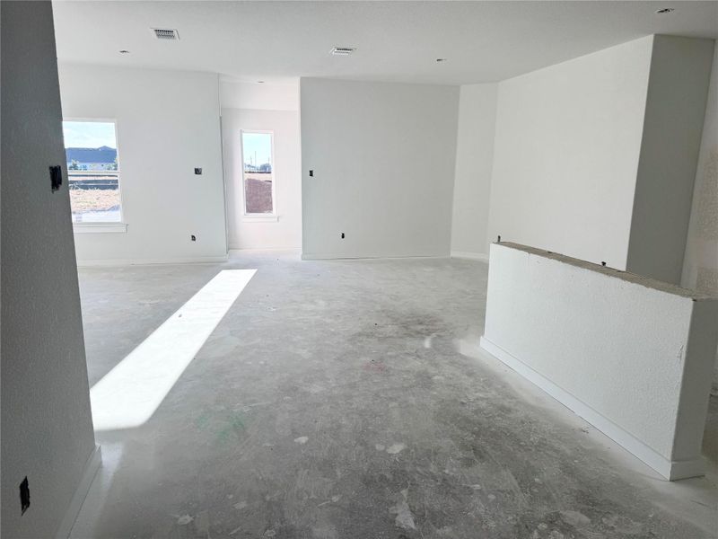 Spare room featuring unfinished concrete floors and baseboards Spare room featuring unfinished concrete floors and baseboards