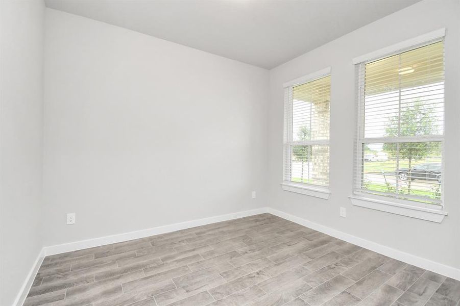 Step into the inviting home office, where elegant tile flooring adds a touch of freshness and comfort to the workspace. Natural light pours through the window, creating an inspiring environment for productivity and focus.