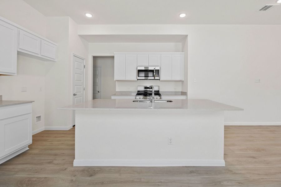 Kitchen in the Elm home plan by Trophy Signature Homes – REPRESENTATIVE PHOTO