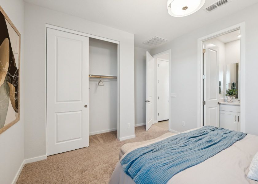 A bedroom with white doors. A bedroom with white doors.