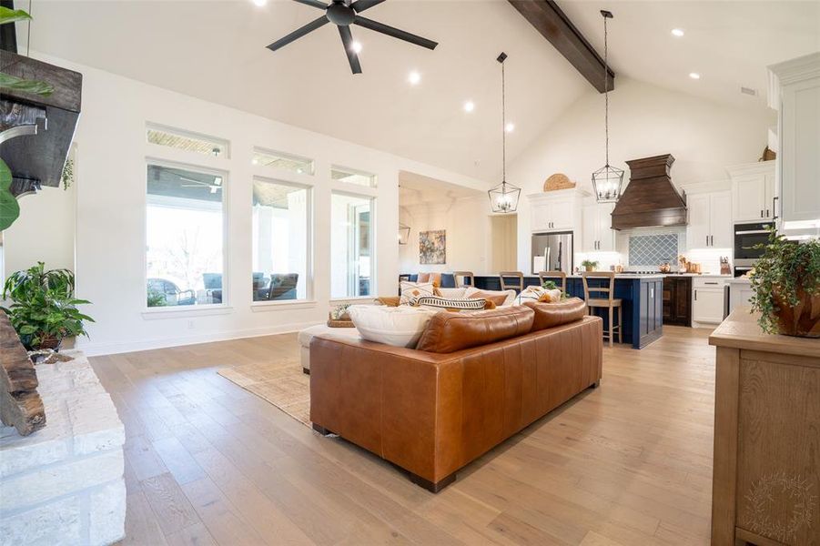 Living room with light wood-style flooring, a ceiling fan, and recessed lighting Living room with light wood-style flooring, a ceiling fan, and recessed lighting