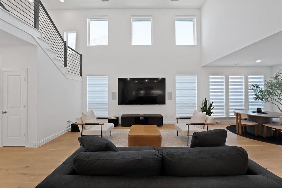 Expansive living area featuring soaring ceilings and light wood-finish flooring