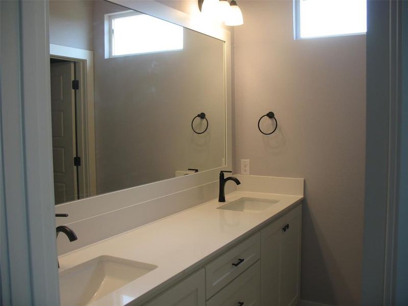 Full bath featuring plenty of natural light and double vanity