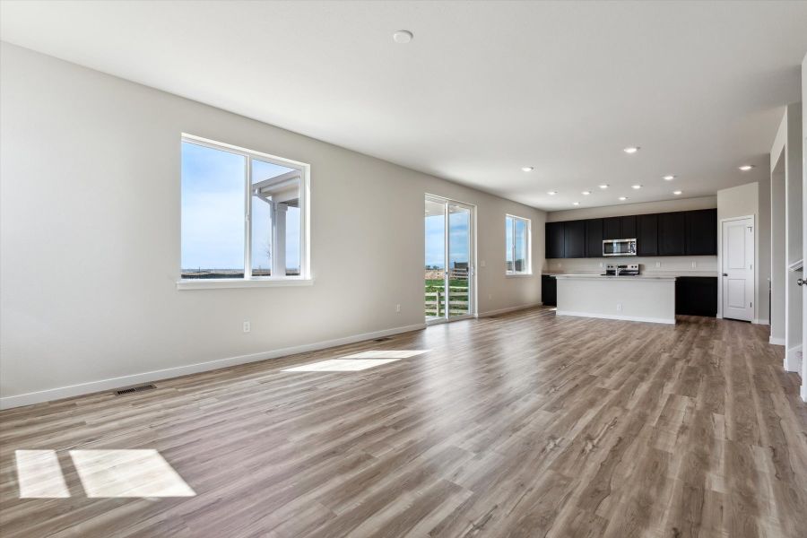 A large empty room with a wood floor.