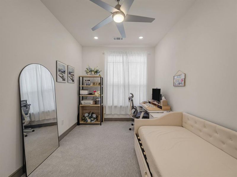 Bedroom featuring a desk, light carpet, a ceiling fan, and recessed lighting Bedroom featuring a desk, light carpet, a ceiling fan, and recessed lighting