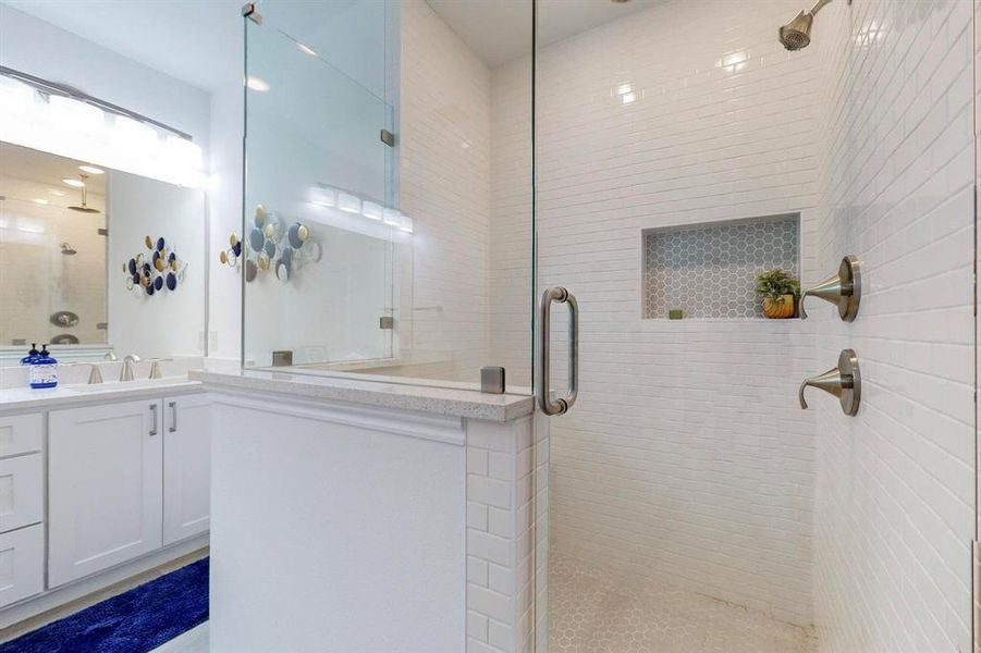 Main Bathroom featuring a shower with door and vanity