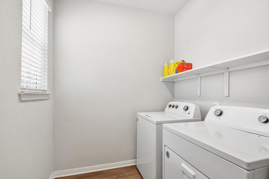 Functional laundry room offers a convenient upper shelf and a window Functional laundry room offers a convenient upper shelf and a window