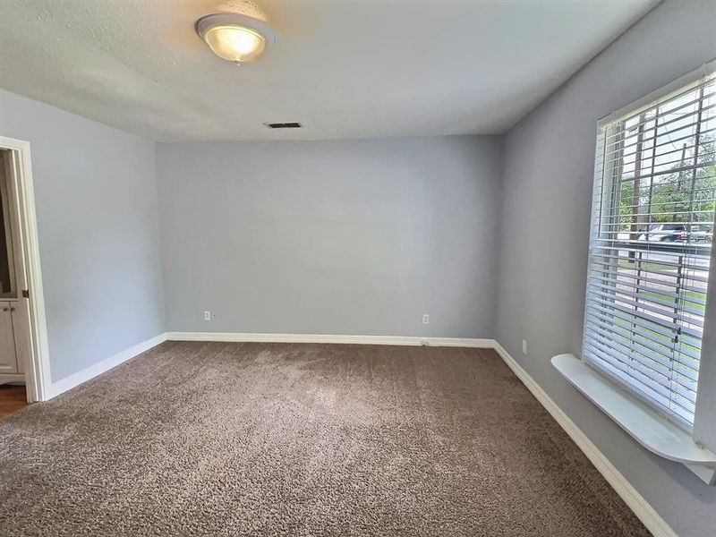 Carpeted spare room with baseboards
