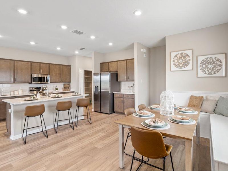 The Mariposa offers plenty space for dining, including an island with counter-height bar - Mariposa townhome by Highland Homes