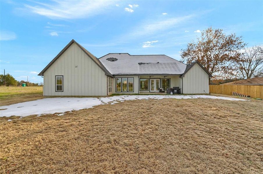 Rear view of property with a patio area and a lawn