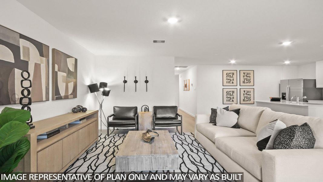 Living area with recessed lighting and light colored carpet