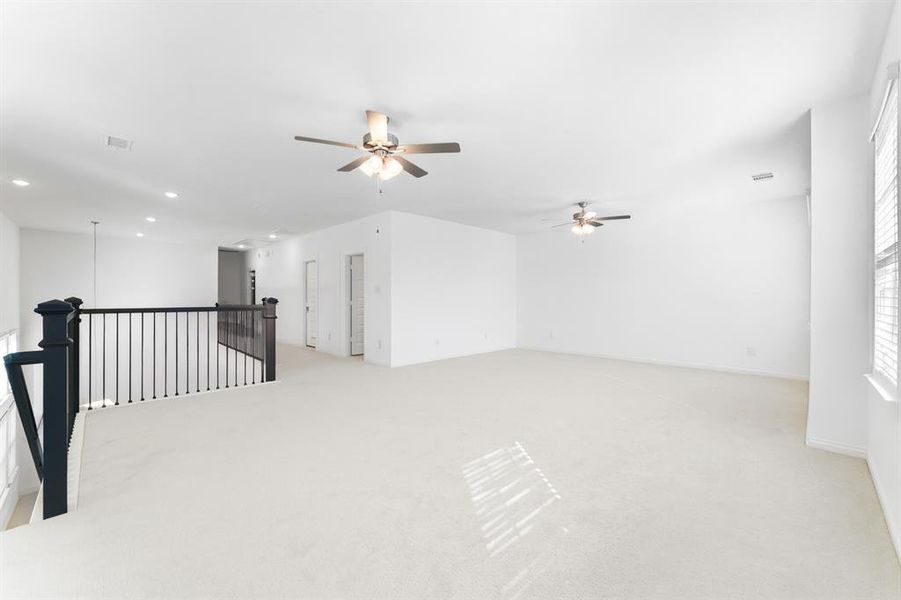 Unfurnished room featuring light carpet, a ceiling fan, and recessed lighting Unfurnished room featuring light carpet, a ceiling fan, and recessed lighting