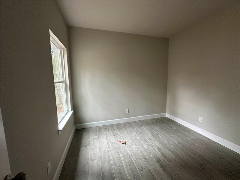 The secondary bedroom is well-sized and features tile flooring along with a nice size window for plenty of natural light.