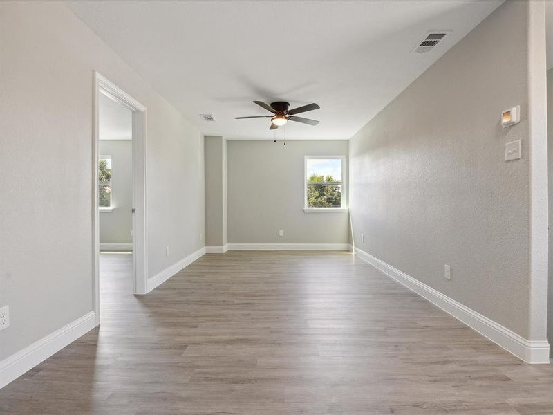 Spare room with light hardwood / wood-style flooring and ceiling fan