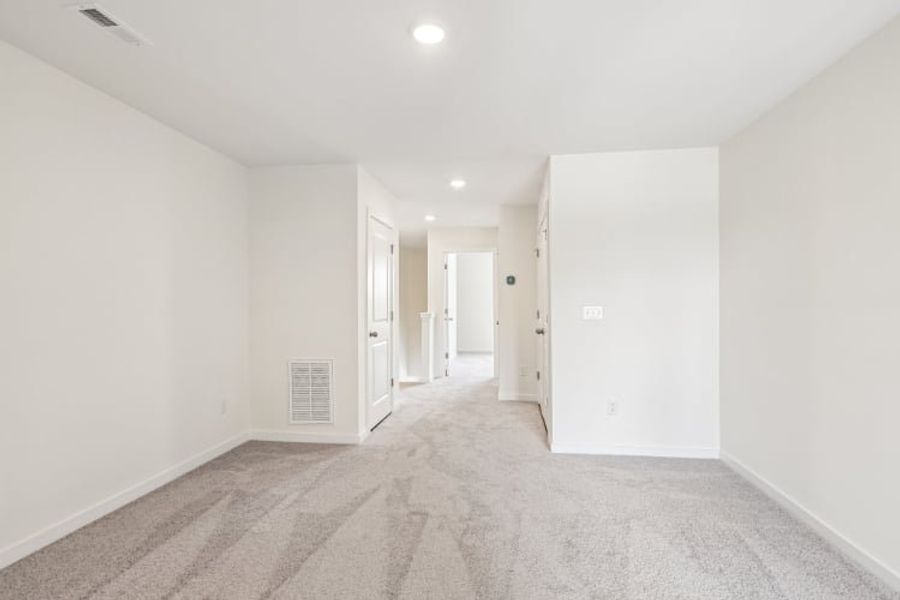 A long hallway with white walls.