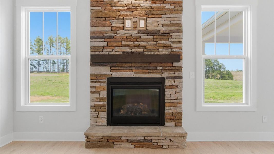 Exceptional family room featuring a stone fireplace and vibrant natural light located in Gray Court, SC
