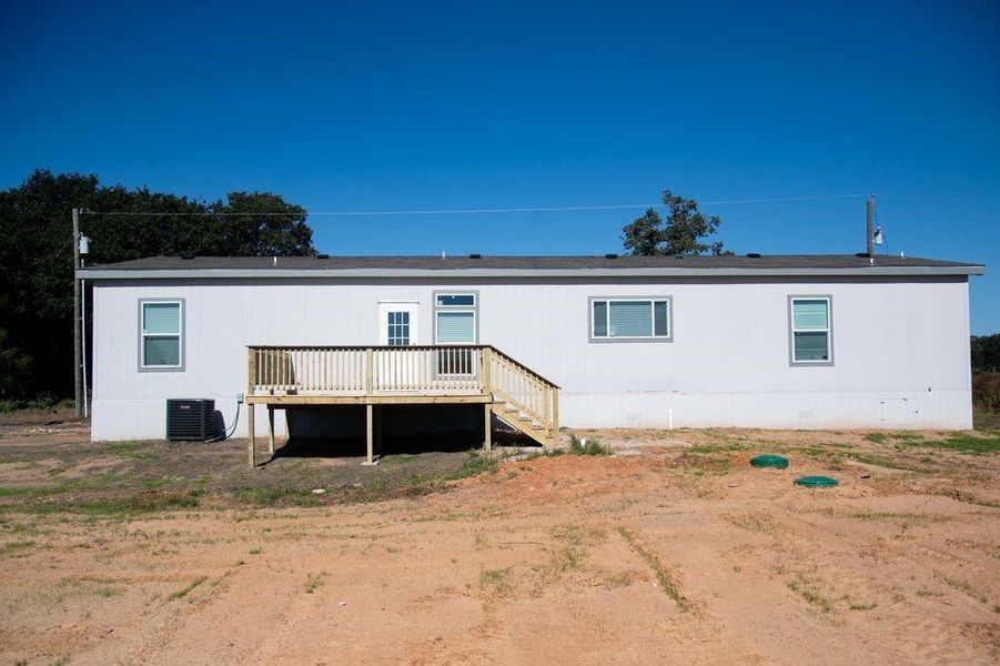 Back of house with a deck and stairway Back of house with a deck and stairway