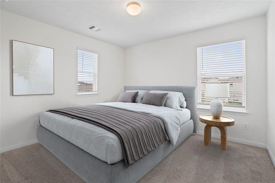 Secondary bedroom features plush carpet, neutral paint, lighting, large windows with privacy blinds and ample sized closet space.