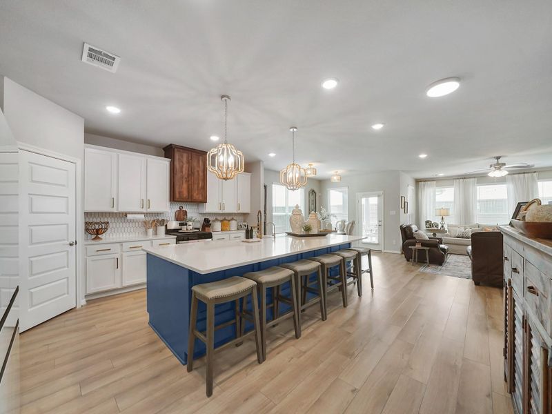 The kitchen opens beautifully to the main living areas, creating a seamless space for gathering, entertaining, and everyday connection.