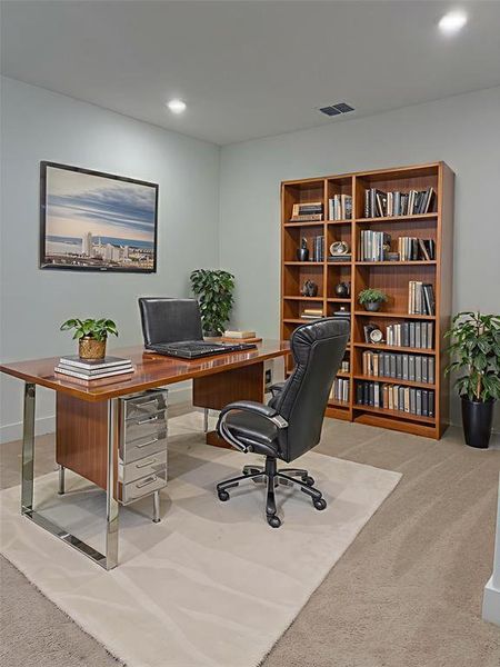 Flex space upstairs with light colored carpet and recessed lighting virtually staged