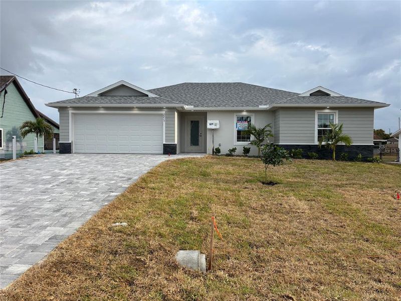Front exterior of a new home in , Cape Coral, FL, highlighting curb appeal (Image 12). Front exterior of a new home in , Cape Coral, FL, highlighting curb appeal (Image 12).