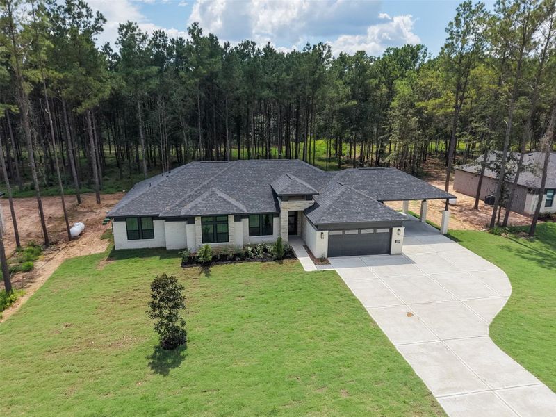 Front exterior of a new home in Deer Pines, Conroe, TX, highlighting curb appeal (Image 22).