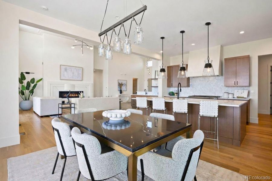 Dining area adjacent to the kitchen with updated pendant light and outdoor access.