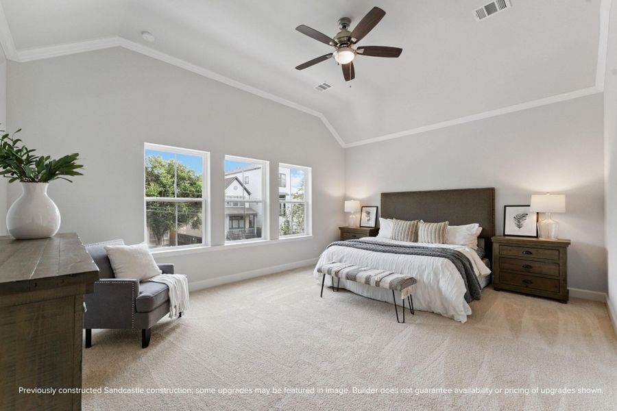 Primary Bedroom Retreat – Vaulted ceilings, plush carpeting, and natural light combine to create a peaceful and spacious haven.