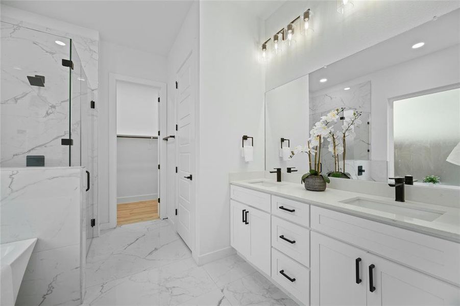 Bathroom with marble tiled floors, a marble finish shower, double vanity, a soaking tub, and recessed lighting Bathroom with marble tiled floors, a marble finish shower, double vanity, a soaking tub, and recessed lighting