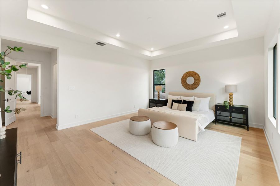 The primary bedroom's impressive size comfortably allows for a sitting area, transforming the space into a comprehensive master suite. This thoughtful layout provides the ultimate in bedroom luxury with dedicated spaces for both rest and relaxation.