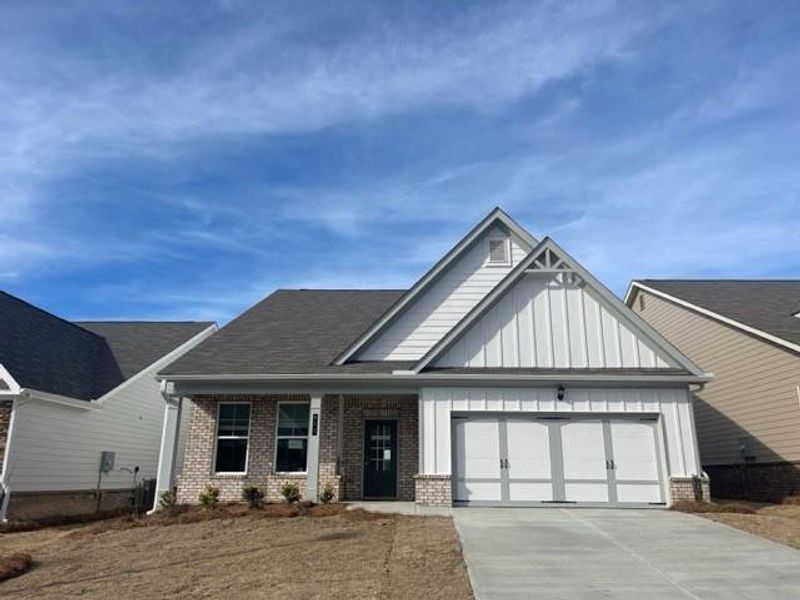 Front exterior of a new home in Cooper's Walk, Loganville, GA, highlighting curb appeal (Image 1).