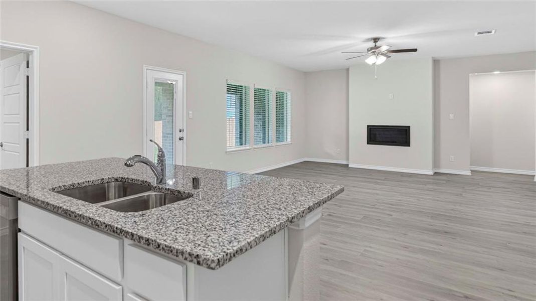 Kitchen island with a double basin stainless steel sink and granite countertop