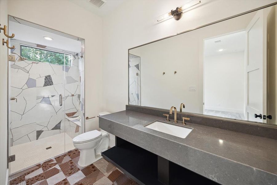 Each bathroom in this home features its own custom color tile, creating a unique and stunning visual experience. From vibrant blues to serene earth tones, the carefully selected tiles add a personalized touch to each space. The custom designs not only enhance the aesthetic appeal but also reflect a distinct character, making every bathroom a one-of-a-kind retreat.