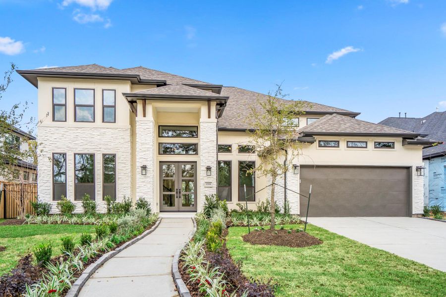 Front exterior of a new home in Sienna 70' Lots, Missouri City, TX, highlighting curb appeal (Image 26). Front exterior of a new home in Sienna 70' Lots, Missouri City, TX, highlighting curb appeal (Image 26).
