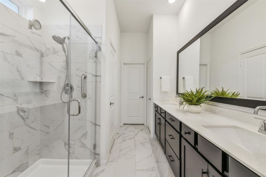 This oversized primary bathroom features double sinks, a full cabinet of drawers, a separate water closet, as well as a linen closet!