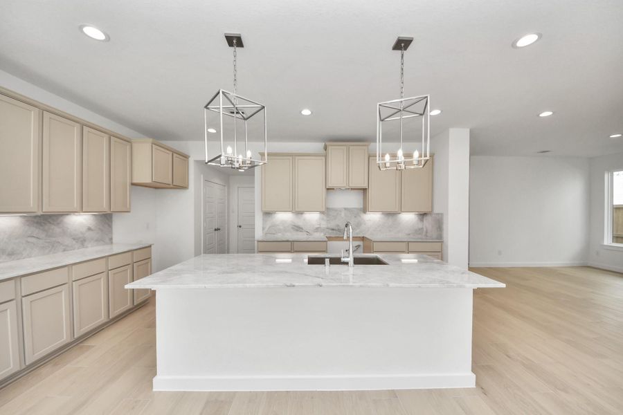 All of this overlooks your expansive family room, creating a perfect space for culinary delights and family gatherings. Sample photo of completed home with similar floor plan. Actual colors and selections may vary.