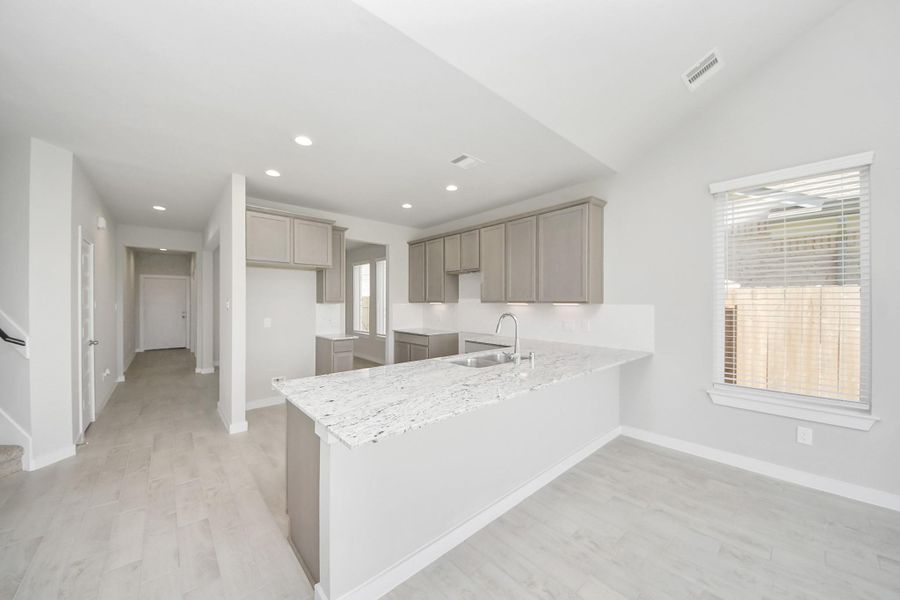 The open concept effortlessly connects the kitchen to the expansive family room, forming a perfect hub for gatherings. This seamless flow creates an inviting space where cooking and socializing come together harmoniously. The open concept effortlessly connects the kitchen to the expansive family room, forming a perfect hub for gatherings. This seamless flow creates an inviting space where cooking and socializing come together harmoniously.