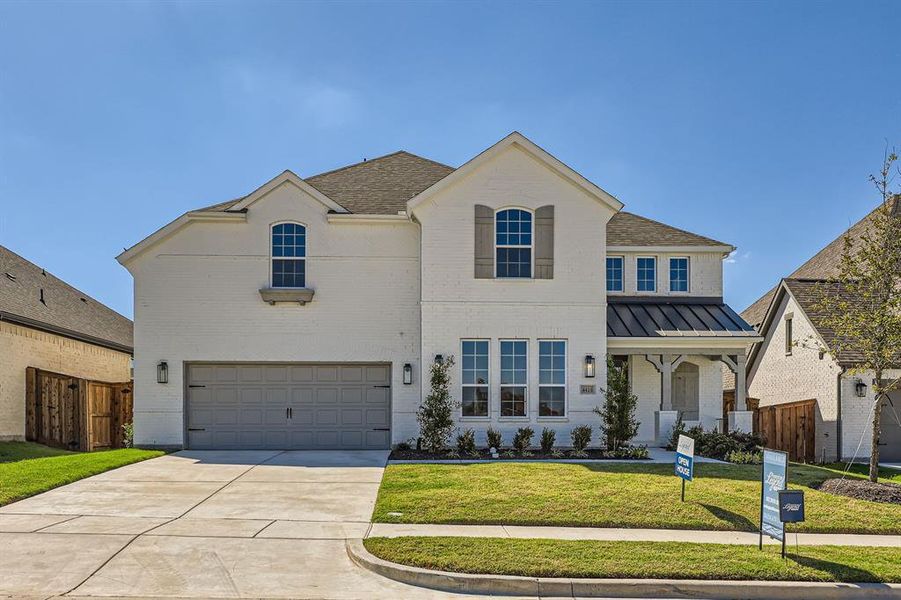 View of front of property with a garage and a front yard