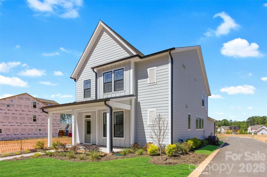 Front exterior of a new home in The River District - Pioneer Collection, Charlotte, NC, highlighting curb appeal (Image 15).